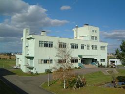 全体が薄い緑色をした士別下水処理場の外観写真