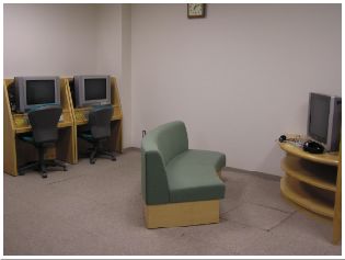 壁にインターネット端末が設置され、カーキー色のソファーが置かれたAV鑑賞コーナーの写真