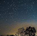 星空と光に照らされた木が映っている画像