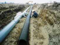 2本の管を地面下に整備している工事の様子の写真