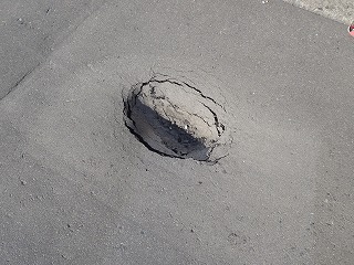 道路の真ん中に穴が開いている写真